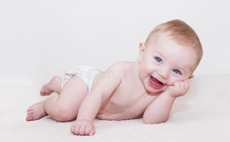 Baby Laying Down And Laughing Stock Image
